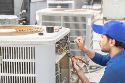 Technician with Refrigerant Equipment